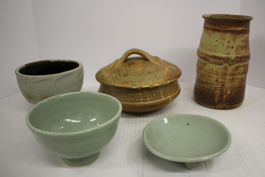 Five Pottery Forms by Warren MacKenzie: Covered casserole. Vase/vessel w/ smooth matte finish. Bowl w/ white stony glaze, faceted exterior, brown high glaze interior. A celadon color three footed saucer and bowl w/ crackle glaze. DIMENSIONS