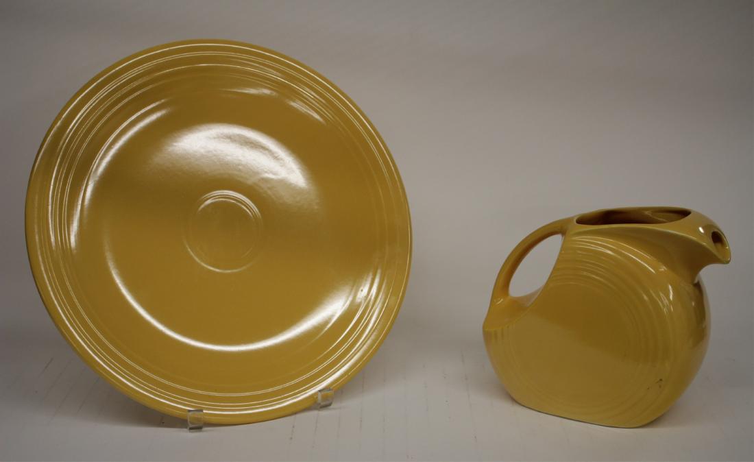 Two Fiesta Ware: Pitcher, Platter in Marigold: Platter is H.L. Co. marked. Pitcher glaze color w/ underlying white near base. DIMENSIONS: Platter 14.25" dia. Pitcher 7.25H We encourage all bidders to obtain shipping quotes before placing bids. (SA