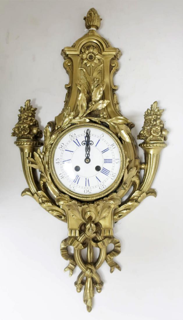 Louis XVI Style Ormolu Cartel Clock Case: White enamel dial with blue Roman numerals. DIMENSIONS: 26.5" x 13" We encourage all bidders to obtain shipping quotes before placing bids. (50SUT4322) (WT)