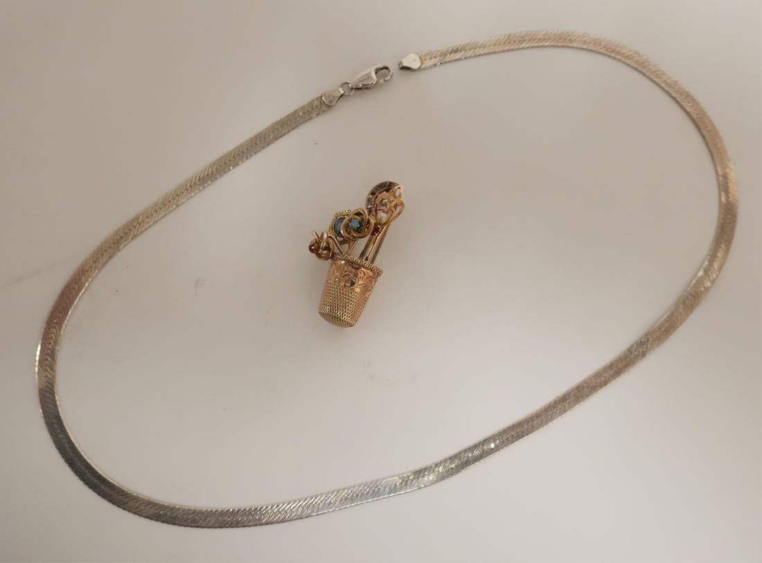 10K Gold Thimble Brooch and 925 Vermeil Choker: 10K Gold Thimble Brooch with flowers and 925 Vermeil Choker. The brooch weighs 5 dwt gross. DIMENSIONS: Choker; 20" l_x000D_ Brooch; 1.5 h. We encourage all bidders to obtain shipping quotes before pl