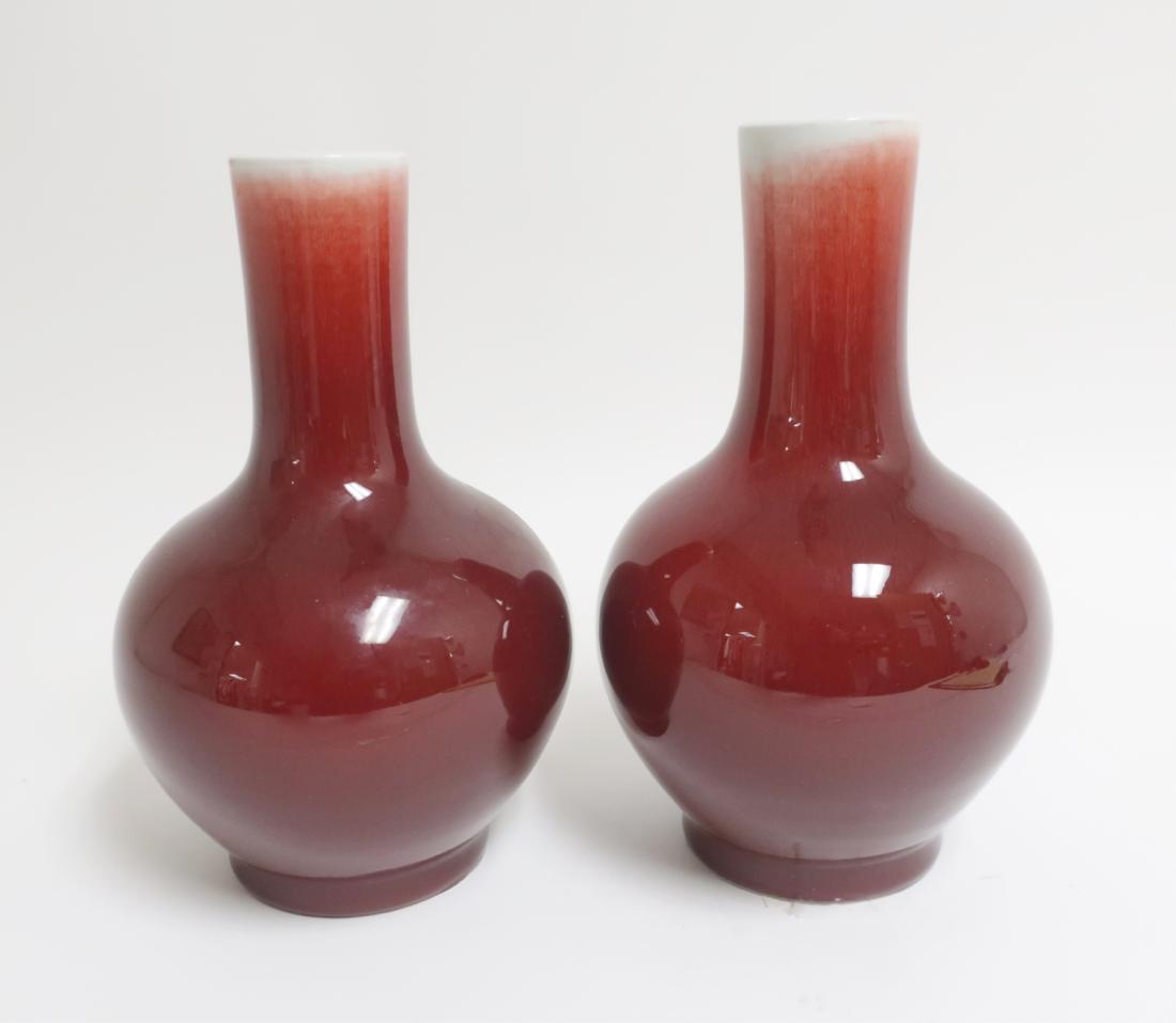 Pr. Chinese Sang de Boeuf Vases: Pr. Chinese Sang de Boeuf Vases, cylindracal neck, porcelain. 11.5" h