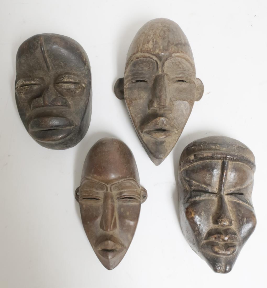 FOUR AFRICAN WOOD MASKS