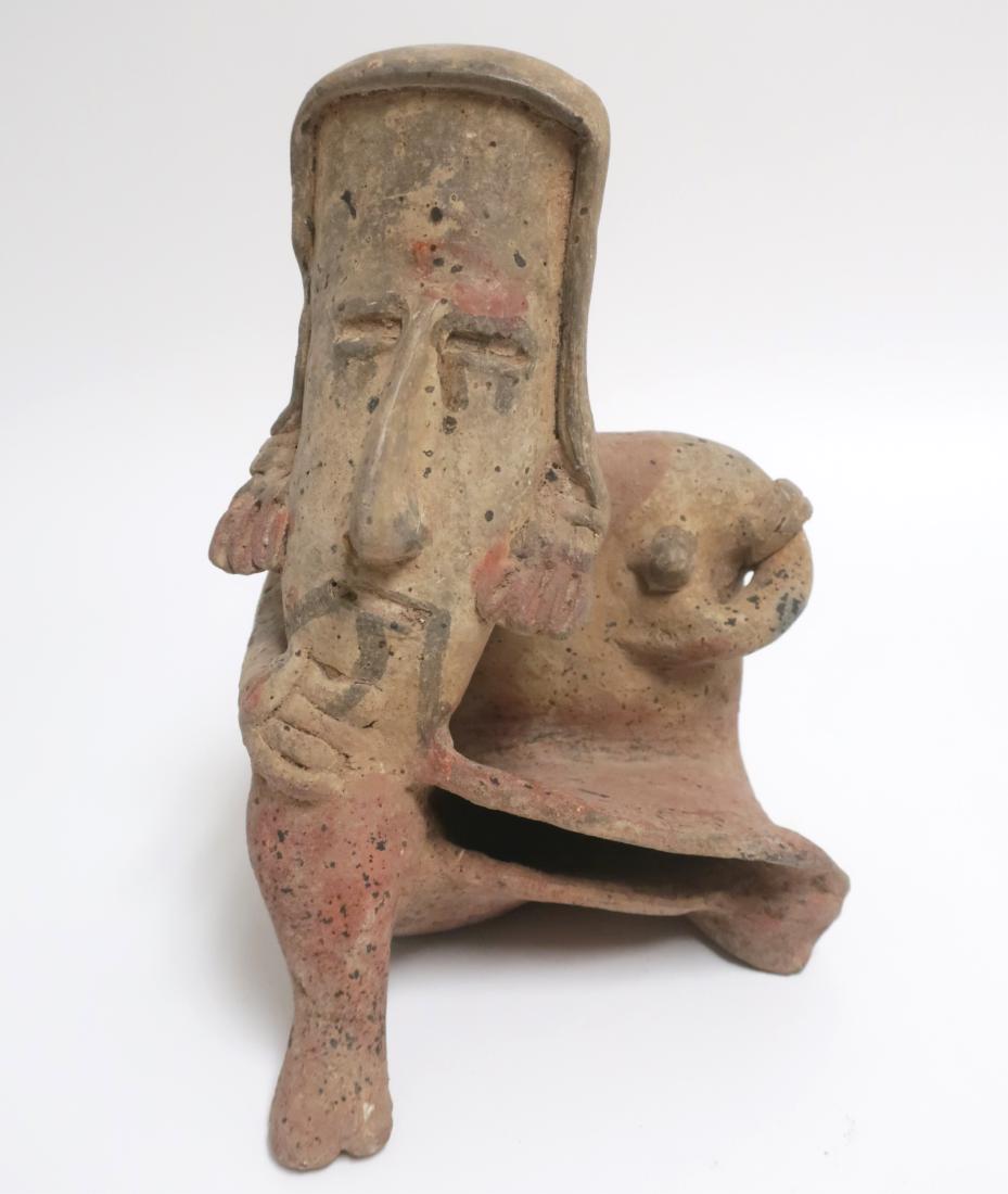 Jalisco Seated Woman, Mexico, c. 300 BC-300 AD: Jalisco Seated Woman, Mexico, c. 300 BC/AD. Terracotta with paint remaining, Woman wears typical Jalisco long skirt, and armbands, earrings and face paint. Dimensions: 9 H x 7 W x 6 D Property from th