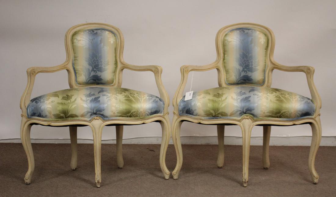 Pair of Louis XVI Style Corner Chairs: Paint decorated in a cream color, floral upholstery. Dimensions: 35 H x 34 W x 19 D. 20" seat height. (BLYTH6023/2)(WT)