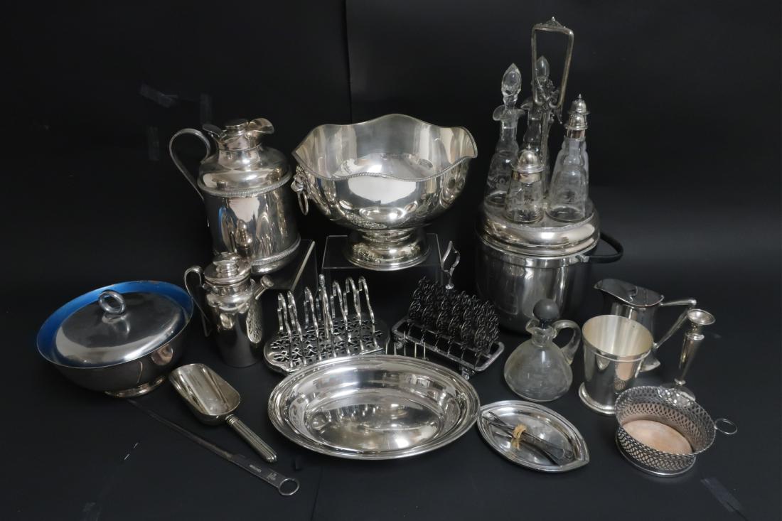 21 Pieces of Assorted Silver Plate: Cruet stand, large bowl w lion mask ring handles, meat skewer, 2 toast racks, bottle coasters, etc Cruet 16 H x 7.5 diam QWIND7005/21 WT