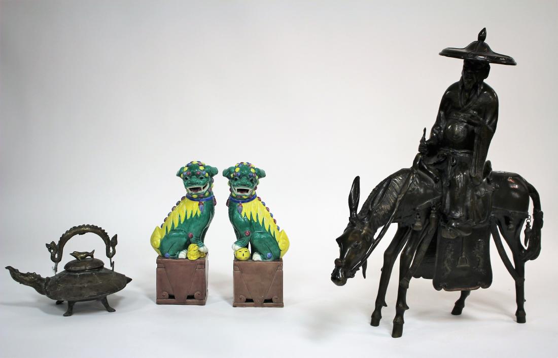 Grp of 20th C. Chinese Decorative Objects: Group of Decorative Chinese Objects, includes pair of porcelain foo dogs, a brass elephant and turtle form pot and a iron scholar riding a donkey Foo Dog 18"H, Teapot 12"H x 15"W x 11"D, Iron figure 3