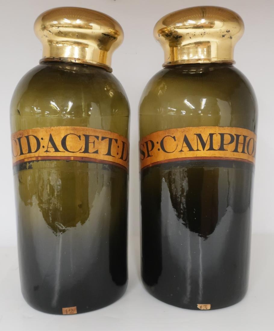 2 Green Glass Apothecary Jars, Camphor and Acid: 2 Green Glass Apothecary Jars, lids later, labeled, SP:CAMPHOR and ACID:ACET:D 15"H x 7"W IBRO787/2 MM