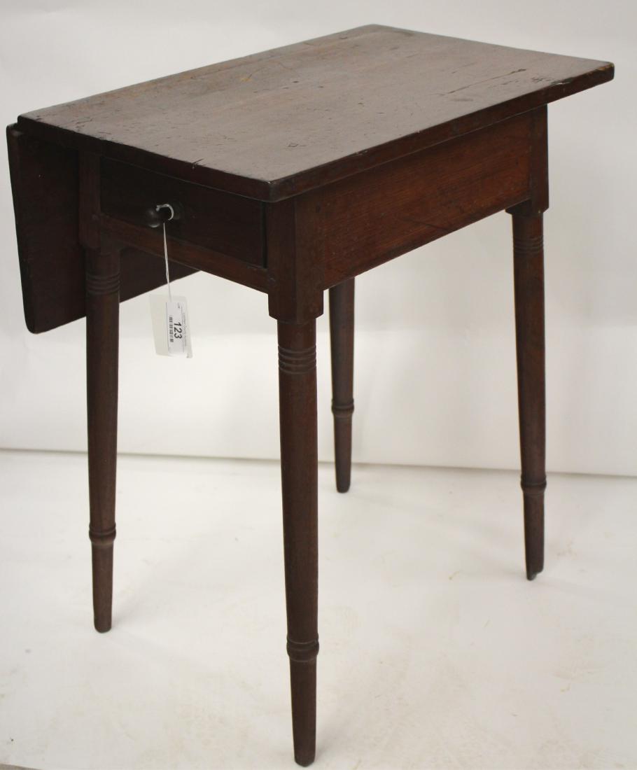 Pine Country Work Table: 1 drawer, 1 drop leaf. Slightly spreading legs and drawer of conforming trapezoidal shape. Pegged construction. 28.5 h by 24 l by 15 w (closed) by9.75 leaf width QWIND7123 WT