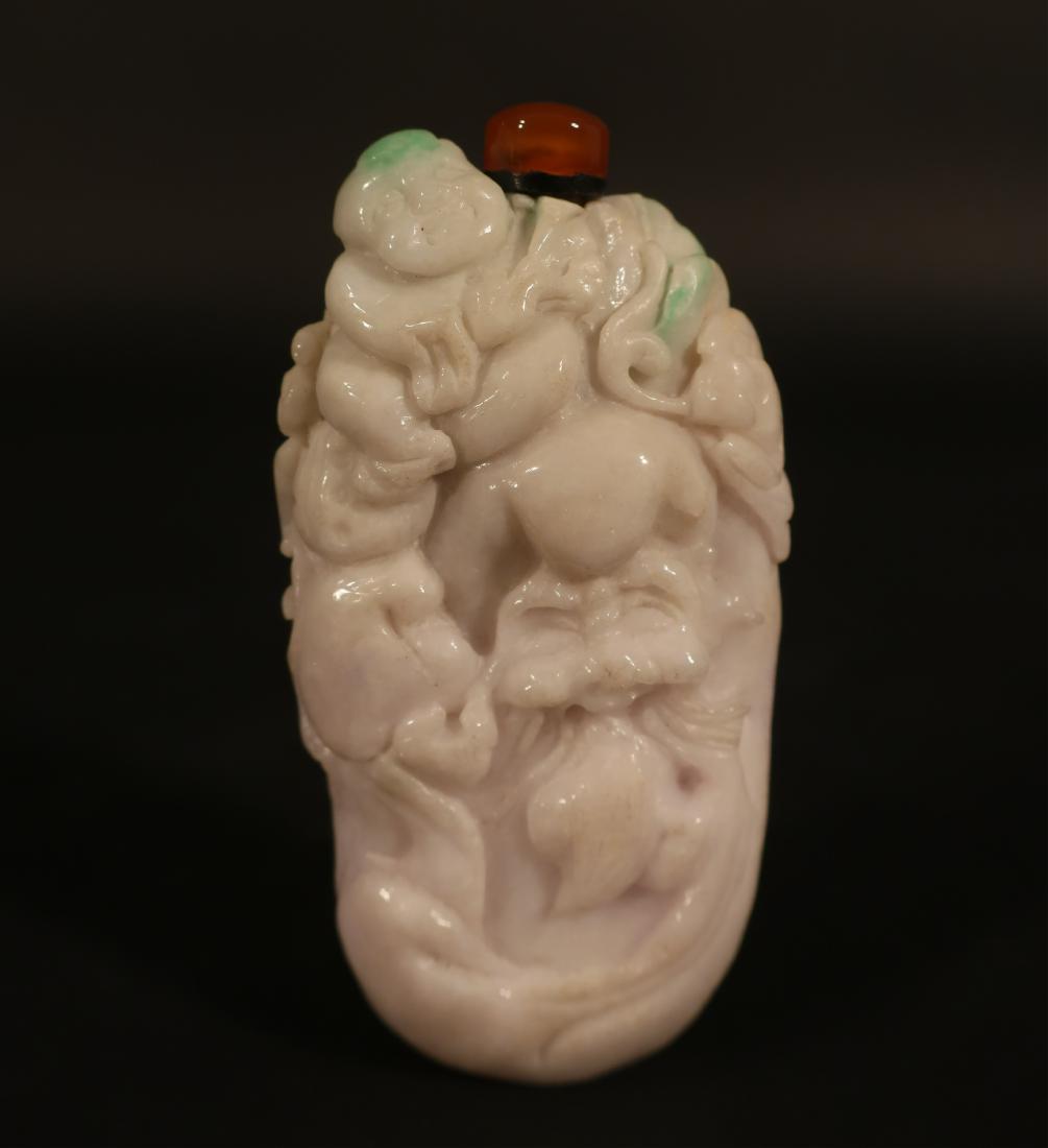 Chinese White Jadeite Snuff Bottle: Flecks of green, carved with a Ho-tei, a mask/face with beard/tongue and fruits and leaves [210] 3 1/2" H x 1 3/4" W HINC35-206 WT