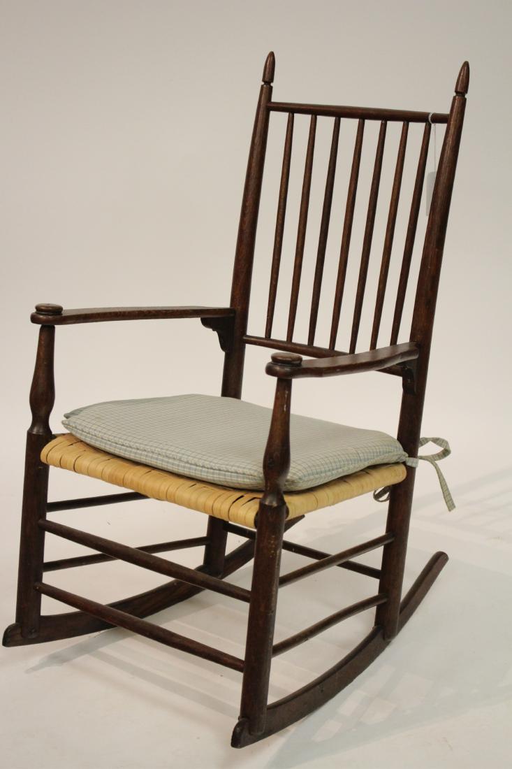 Antique American Rocker, Basket Splints: with a seat cushion 39" H at back, 28" D, 21" W, seat approx 16" H Property from the estate of Philip Roth. Philip Roth was born in Newark New Jersey on 19 March, 1933. The second child of second-gene