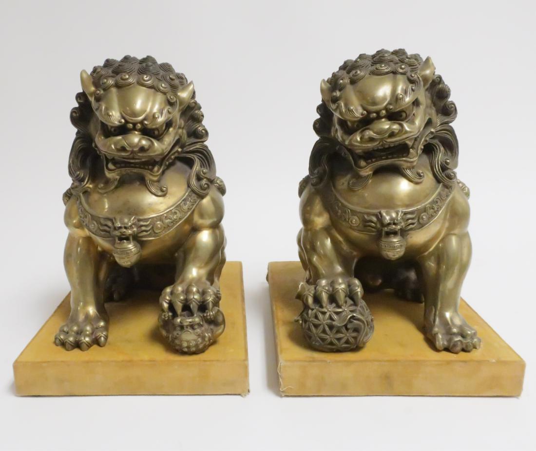 Pair of Chinese Gilt Bronze Guardian Lions: On cloth covered bases. 9.75 H x 10 W x 12 L (HINC8401)(wt)