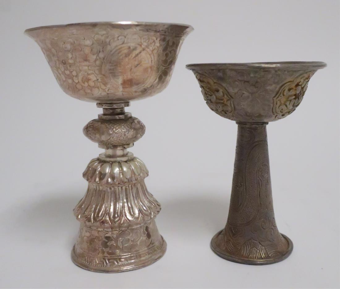 2 Tibetan Yak Butter Lamps, 19th c.: the smaller possibly silver with a turquoise inset into its bowl and traces of gold wash, the larger appears to be silver with lotus petal-like ribs, 8 troy ounces total smaller 3.75" H, th larger 4.5
