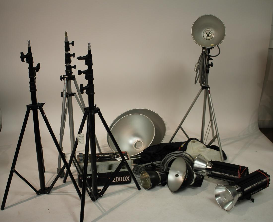Photography Lighting Equipment: Norman power pak model P2000X, (3) Norman LH2400 lights, (2) White Lightning Ultra lights, Bogen wheeled light stand model 3082, Bogen aluminum stand, (2) Avenger Italy stands model A635B, misc. cones