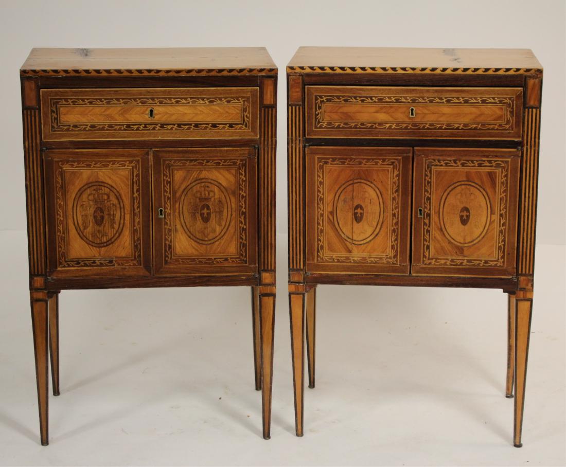 Pr. Italian Neoclassical Marquetry Commodini: Late 18C. Each w/ drawer over pr. cabinet doors. Wave pattern along top edge. Drawn in design within oval. Replaced, veneer gone, or once with separate marble tops. Key lock doorss, drawers. 33"H x 20