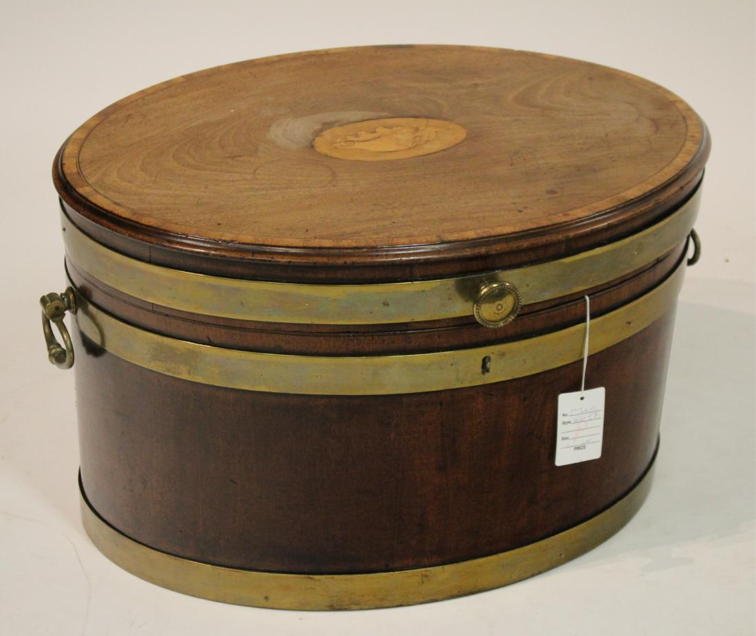 Regency Shell Inlaid Mahogany Oval Cellarette: Early 19th c, oval with brass banding and handles. 14.5 h by 24 l by 18 d Property from the Estate of Jo Sullivan Loesser (FJLO8697)(wt)