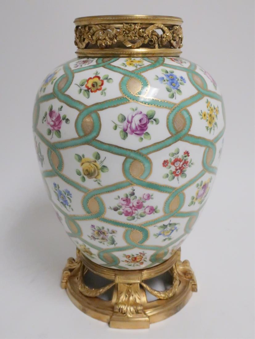 Porcelain Vase with Ormolu Mounts, Prob Sevres: Represented to have the Y marked for Sevres 1736 on bottom. Green and gold entwined chain surrounding flowers 15 H x 9" diam (MANDS8226)(WT)