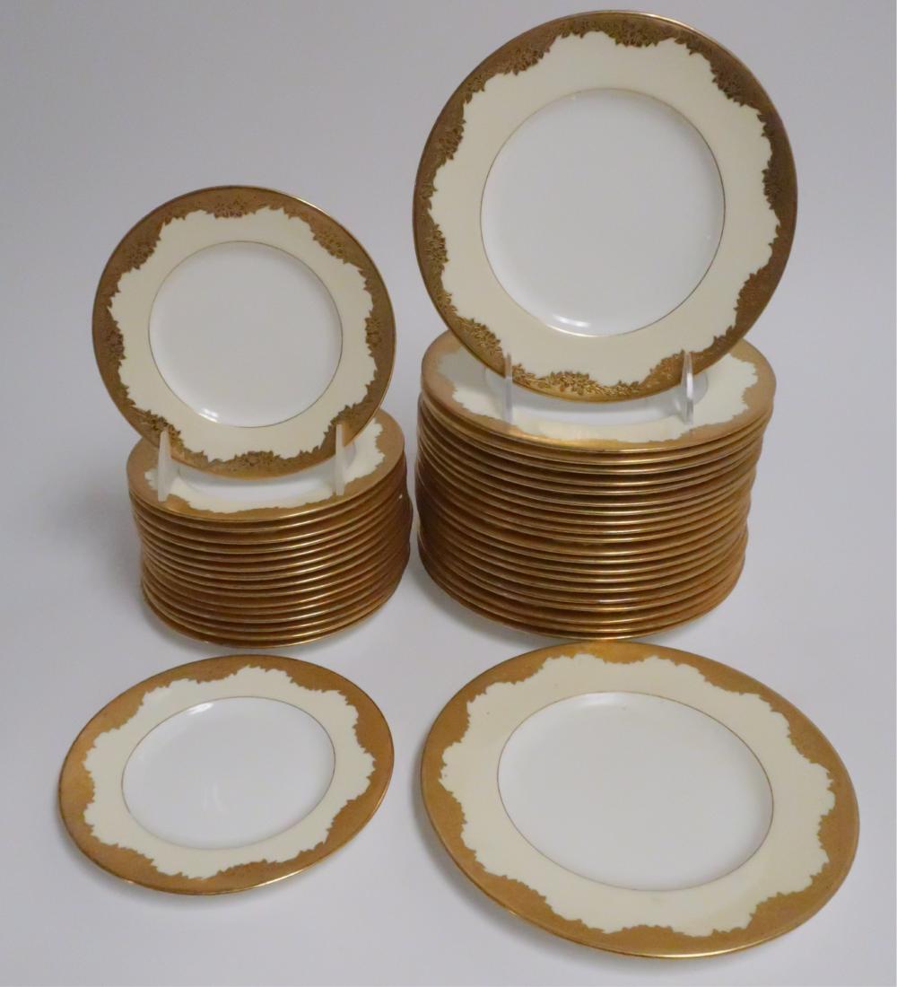 Minton Porcelain Gold Rimmed Plates: Leaf & flower design. 22 salad plates, 17 bread plates. 6" and 7.75" diameter Property from the Estate of Rosalie Coe Weir (ROCO8452/39)(WT)