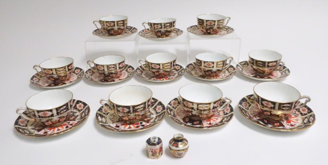 12 Royal Crown Derby Porcelain Cups & Saucers: Imari patter, retailed by Tiffany with 2 miniature jars. Jars 1.5" high Property from the Estate of Rosalie Coe Weir (ROCO8459/12)(WT)