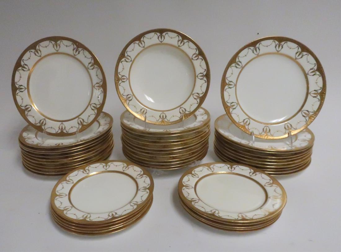 Minton Porcelain Dinner Service: Raised gold swag border. 21 dinner plates, 12 soup & 10 luncheon. Dinner 10.5" diam Property from the Estate of Rosalie Coe Weir (ROCO8461/43)(WT)