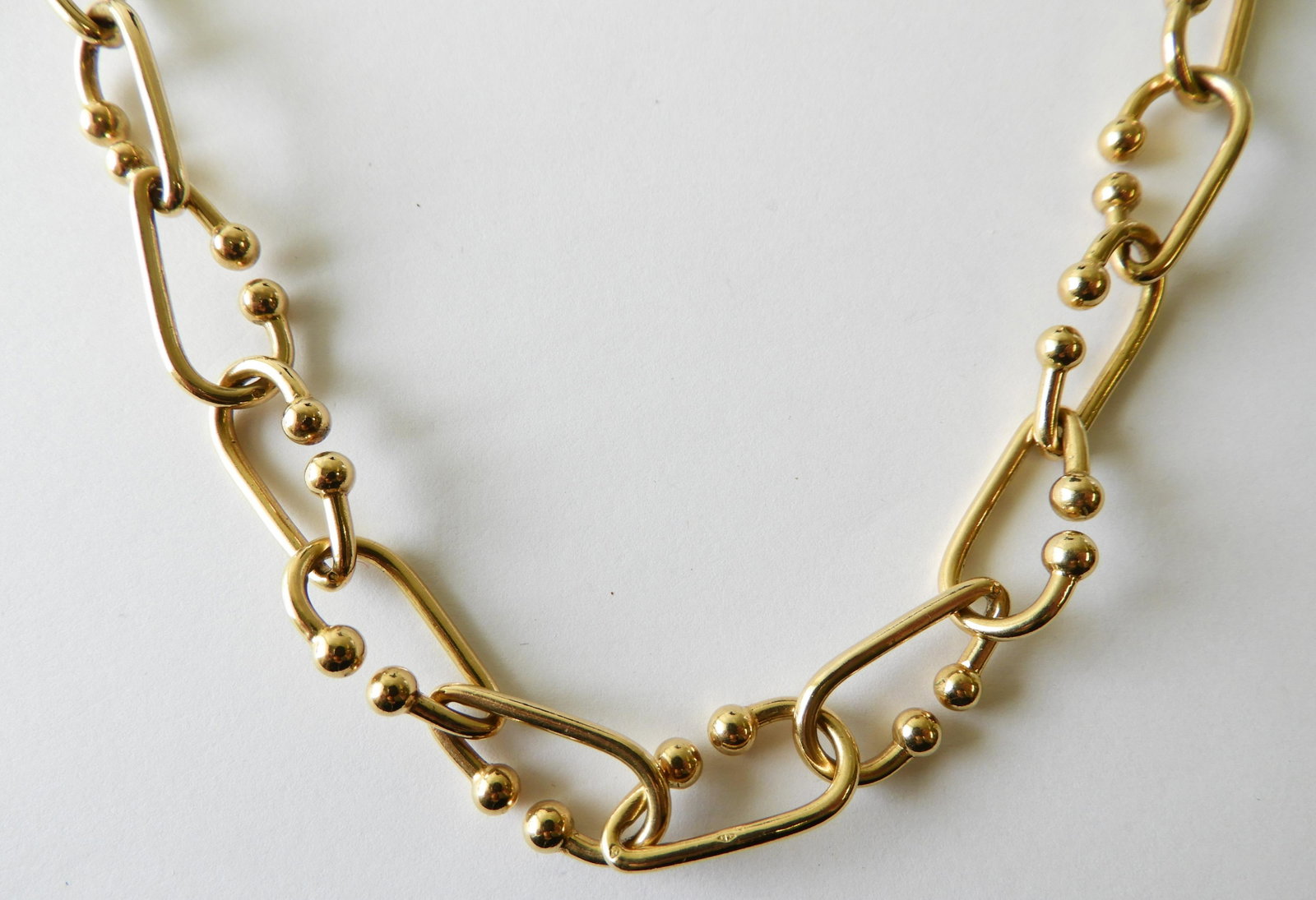 18K Yellow Gold Link Necklace: 24" 18K yellow gold modern link necklace stamped with an eagle head (French for 18K). Weighs 115.8 grams. Property from the estate of Rosalie Coe Weir