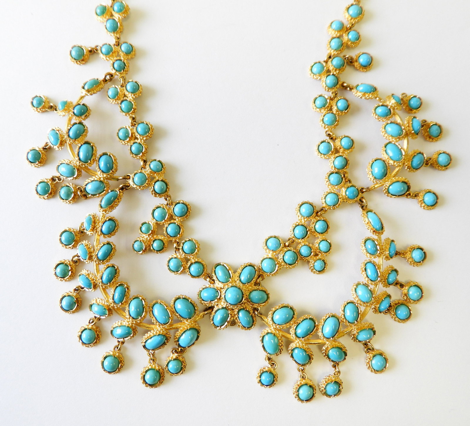 18K Yellow Gold & Turquoise Swag Necklace: Featuring round and oval turquoise with central flower. Gross weight of 49.5 dwt. Property from the estate of Rosalie Coe Weir