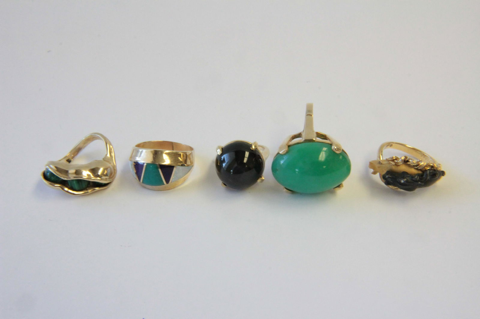 Group of 14/18K Gold Rings: - 14K yellow gold & malachite 3 peas in a pod ring. Size 4.75 - 18K yellow gold & steel horse head ring. Numbered 752585. Size 6. - 14k yellow gold & cabochon chrysoprase ring. Size 6.75. - 14K yellow