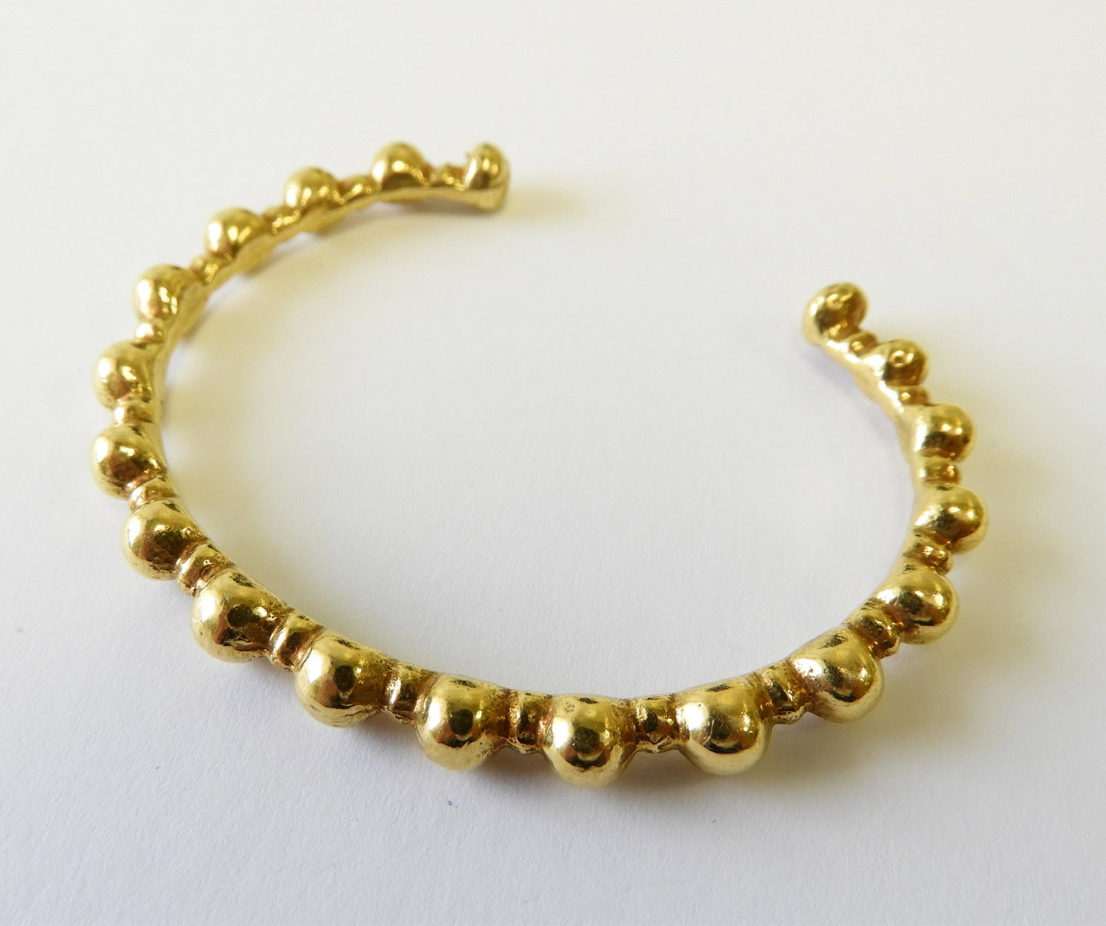 22k Bead Cuff Bracelet: Apparently unmarked but tests as 22k gold. 2.5" width. Gross weight of 26 grams. Property from the estate of Jo Sullivan Loesser