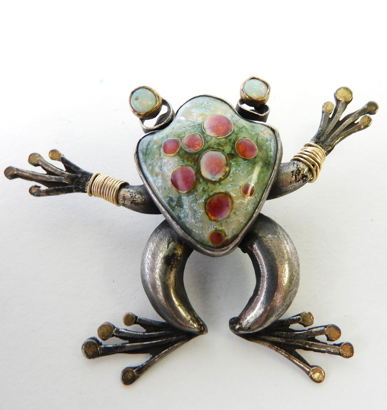 Tree Frog Brooch - Sterling & 14k: Sterling silver and 14k gold tree frog brooch by Kristin Holeman. Cloisonne enamel body with cabochon opal eyes. Signed on back. 3.5" across. Can also be worn as pendant. Property from the estate of R