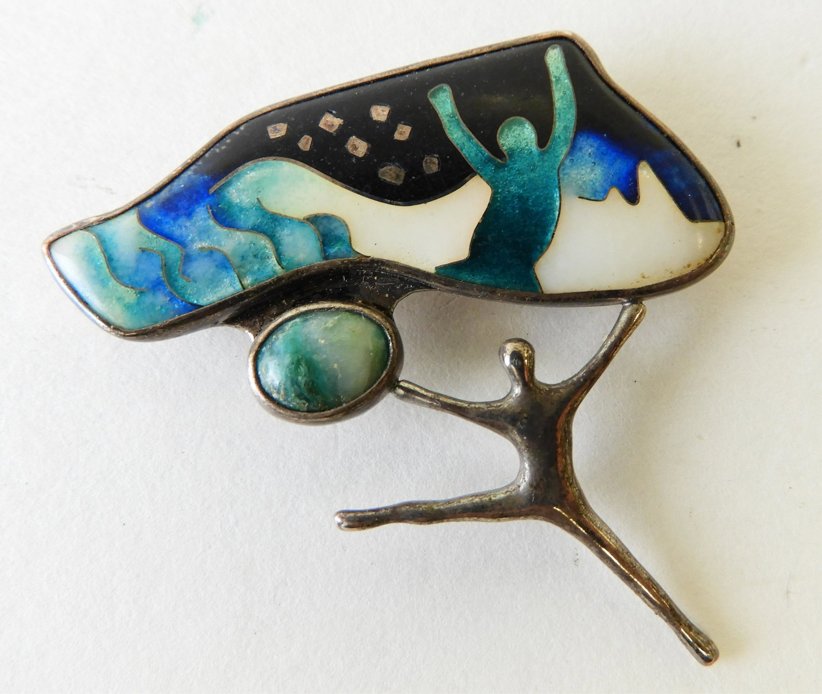 "Dancing Free" Enamel Brooch - Ricky Frank: Sterling silver and cloisonne enamel brooch titled "Dancing Free" signed R. Frank, '89. 1.75" wide. Property from the estate of Rosalie Coe Weir