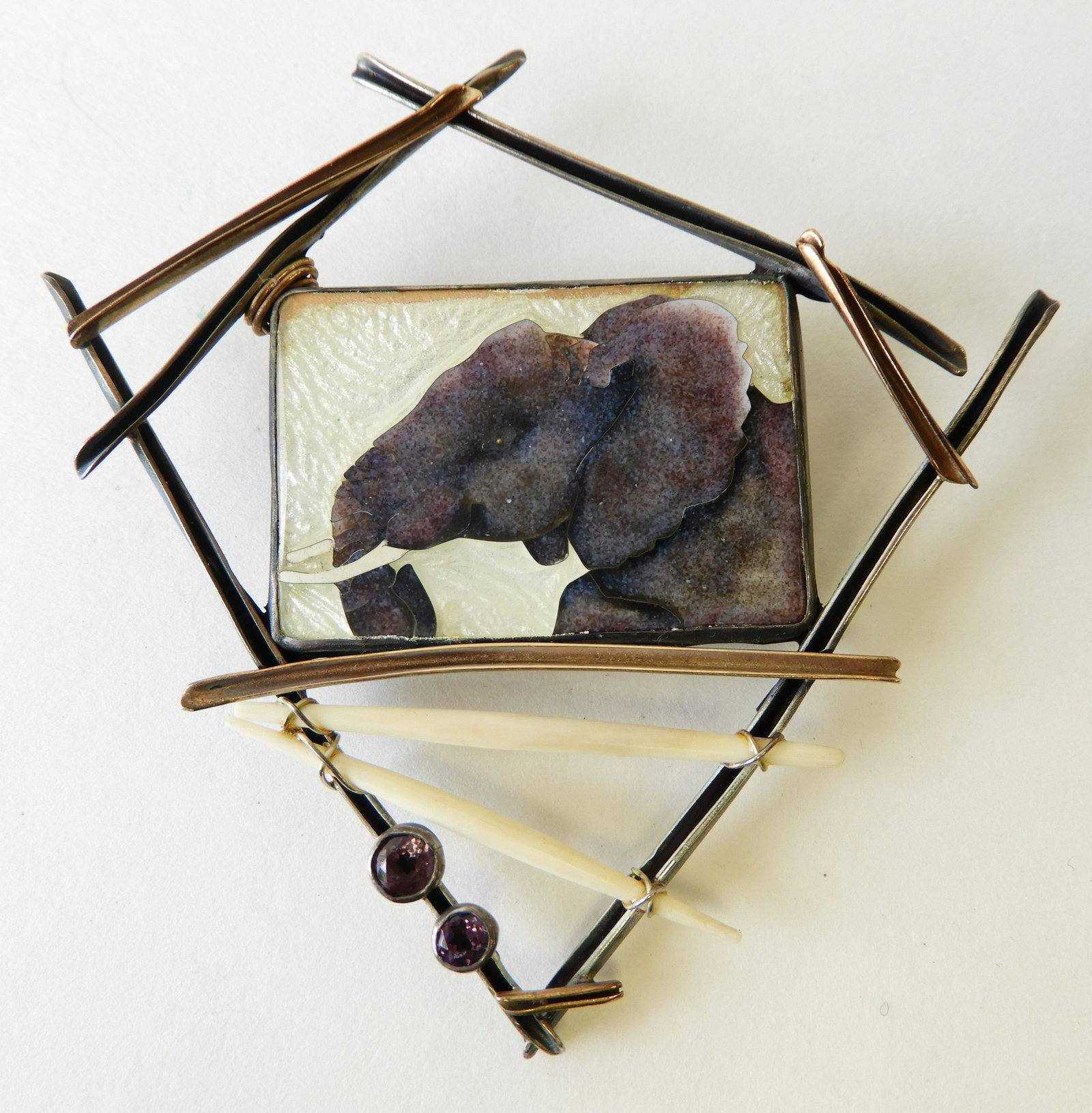 African Elephant Enamel Brooch/Pendant: Sterling silver and 14k yellow gold brooch/pendant featuring a cloisonne enamel African Elephant with faceted amethyst gems by Kristin Schwartz (Holeman) Property from the estate of Rosalie Coe Weir