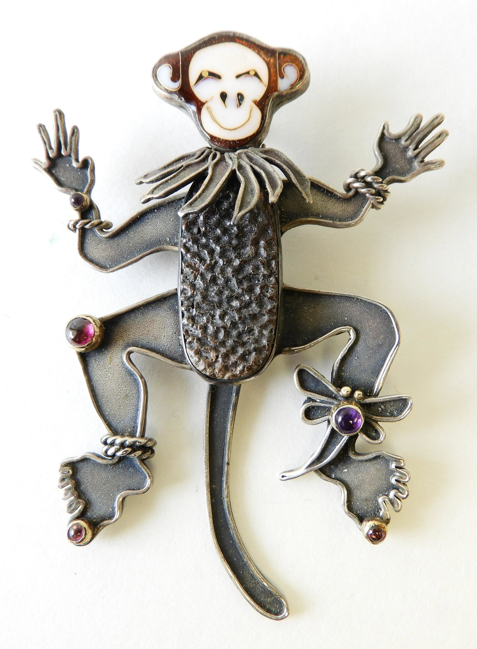 Enamel & Sterling Monkey Brooch: Sterling silver, 22k and 24k monkey brooch with cloisonne enamel face and various hardstone details. Signed Kristin Holeman on back. Property from the estate of Rosalie Coe Weir