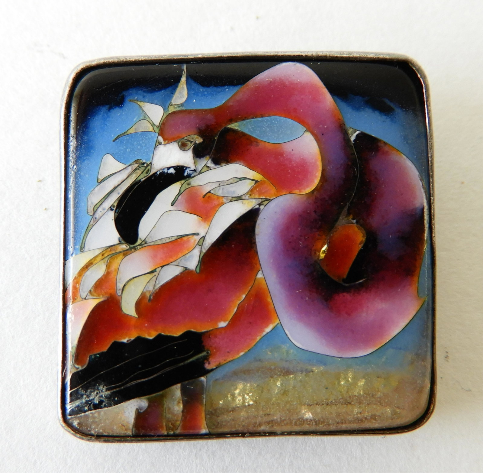 Cloisonne Enamel Flamingo Brooch: Brooch with cloisonne enamel flamingo. Unsigned but most likely designed by Kristin Holeman. 1" square. Property from the estate of Rosalie Coe Weir