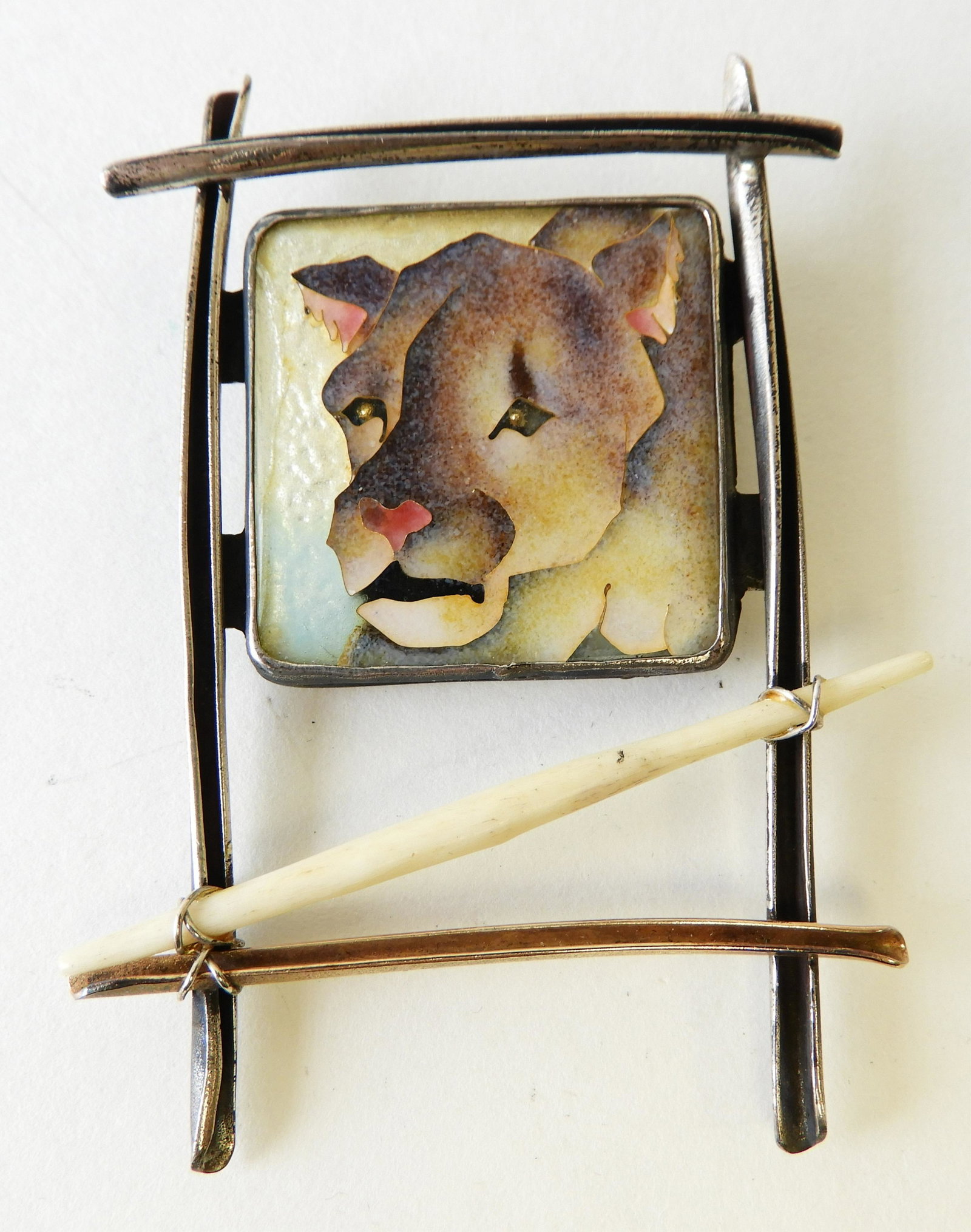 Enamel Cougar Brooch: Sterling silver brooch featuring a cloisonne enamel cougar. Signed Kristin Holeman. 3" x 1.75" Property from the estate of Rosalie Coe Weir