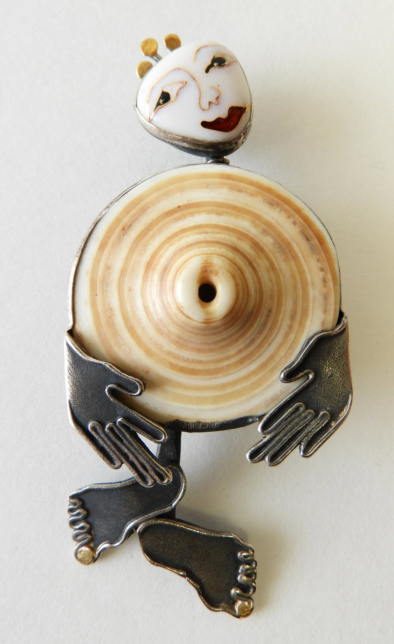 Shell Body Figure Brooch - Sterling & 24k: Sterling silver and 24k figure with cloisonne enamel face and shell body by Kristin Holeman. 3" long Property from the estate of Rosalie Coe Weir
