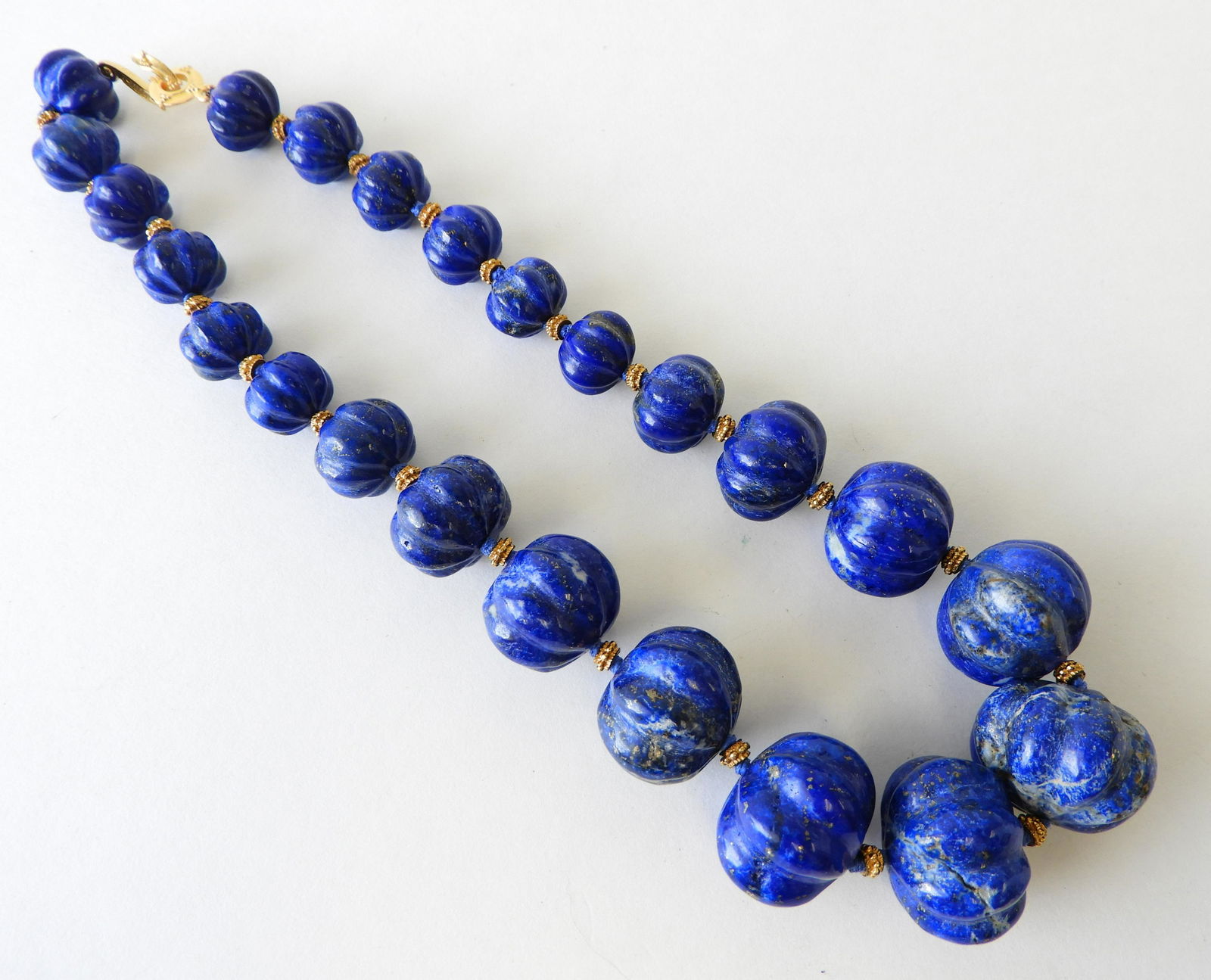 Lapis Lazuli Necklace: 23 Graduated size lapis beads measure approximately 28 to 16mm diameter. Clasp marked MMA. 18" long. Property from the estate of Rosalie Coe Weir