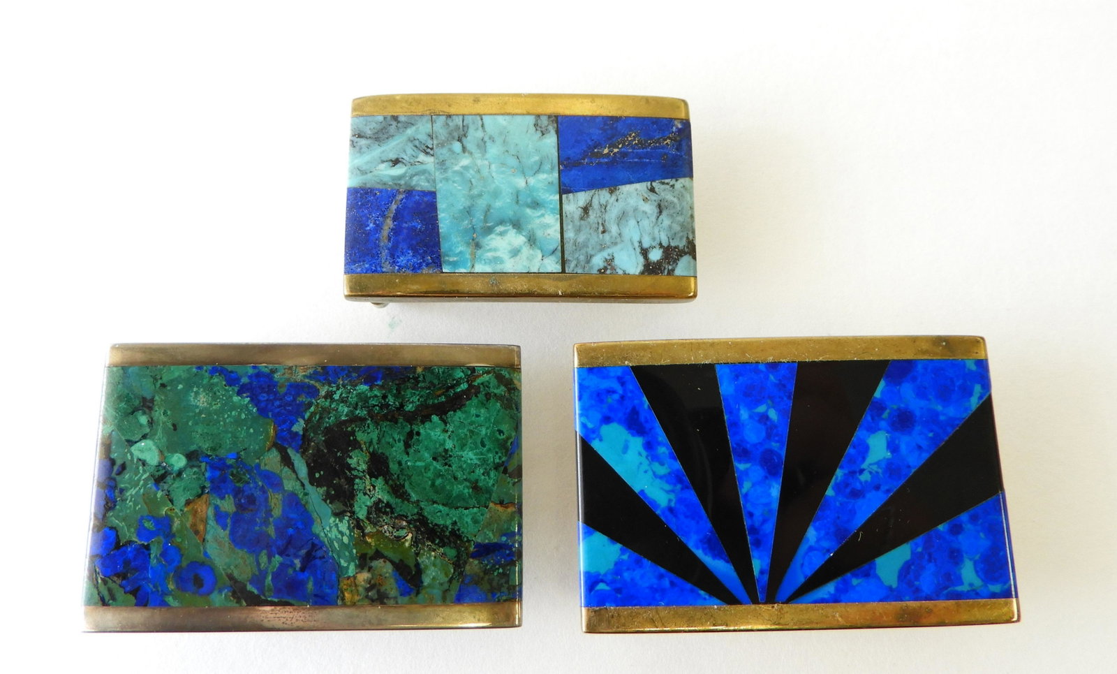 Three Hardstone Belt Buckles: Unknown maker's mark on back. 1.25" H x 2" W and 1" H x 1.75" W Property from the estate of Rosalie Coe Weir