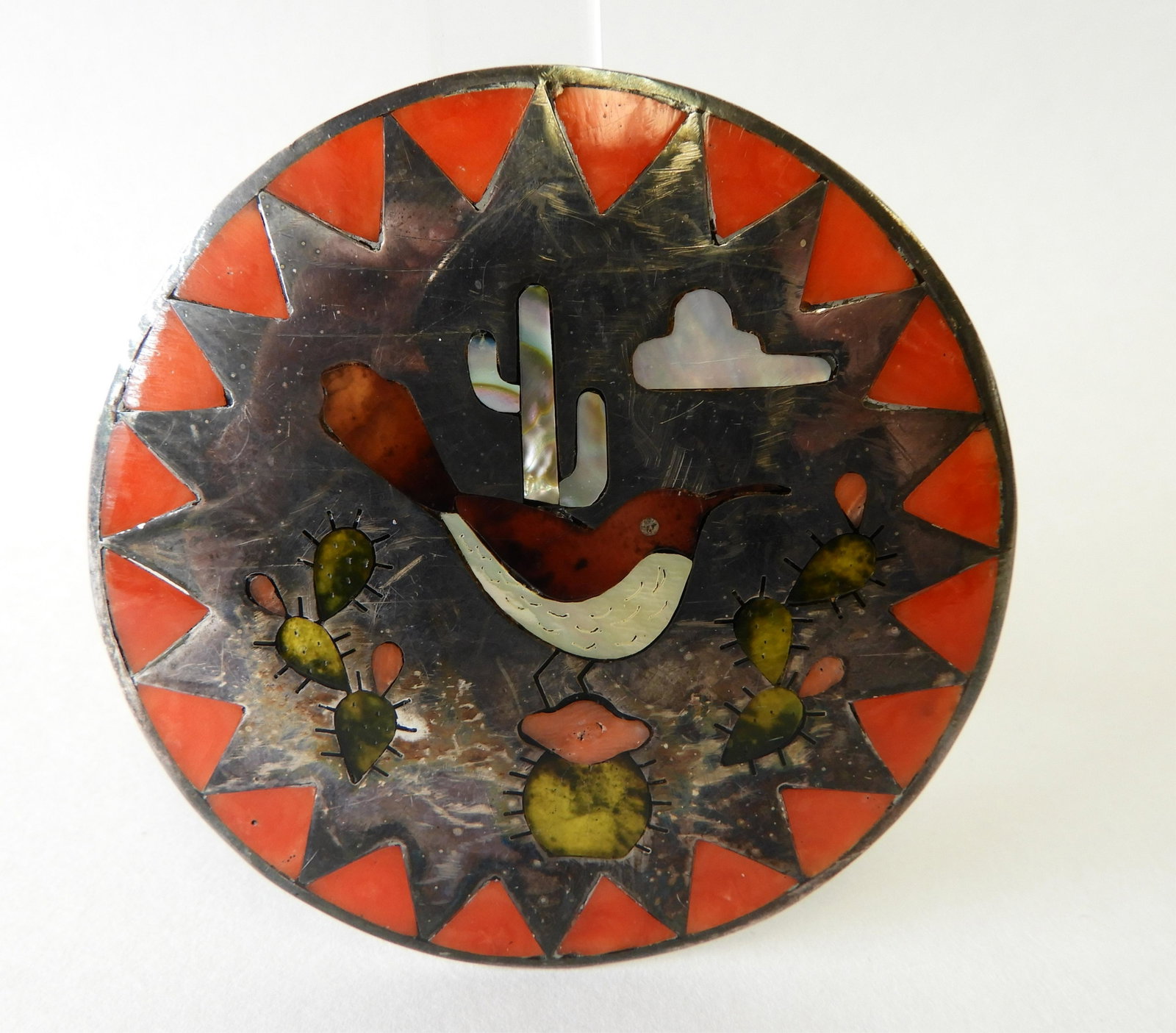 Sammy and Esther Guardian Zuni Belt Buckle: Circa 1975. Inlaid with hardstone and mother of pearl. 3" diameter. Property from the estate of Jo Sullivan Loesser