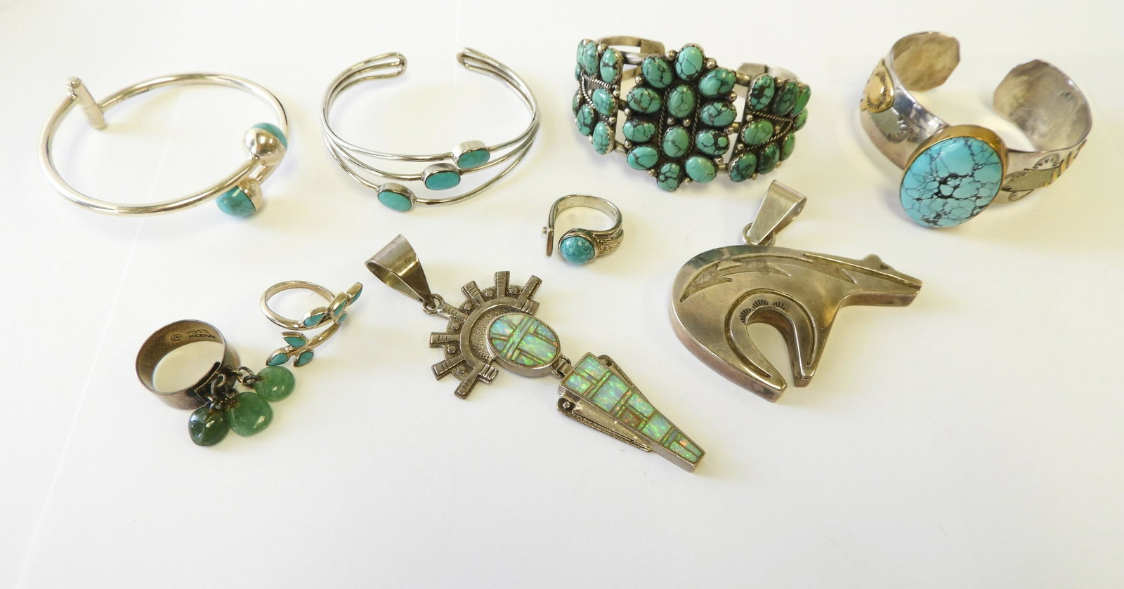 Group of Sterling Southwestern Jewelry: Some pieces are native, some marked Mexico. All sterling silver and hardstone. 4 cuffs, 3 rings, 2 pendants. Includes cuff signed A. Franciso, cuff signed RJ, etc. Mother of pearl pendant is 4" long. 