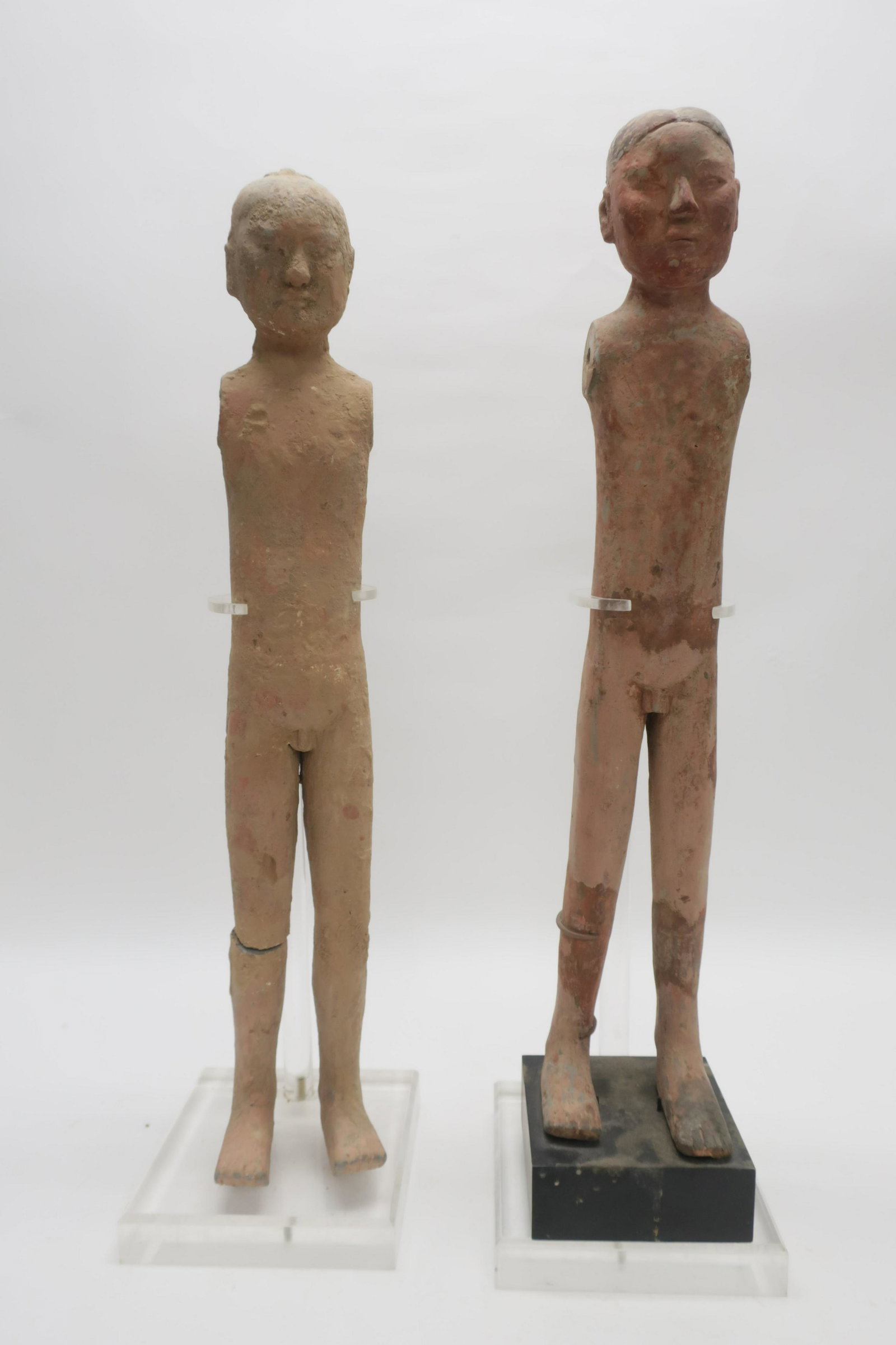 Two Han Stick Figures: Two terracotta "stick boy" figures from Han Dynasty. Buried in tombs originally with wooden arms and clothing. 24" and 23" high Property from a private collection - East 66th at Madison Ave, Manhattan