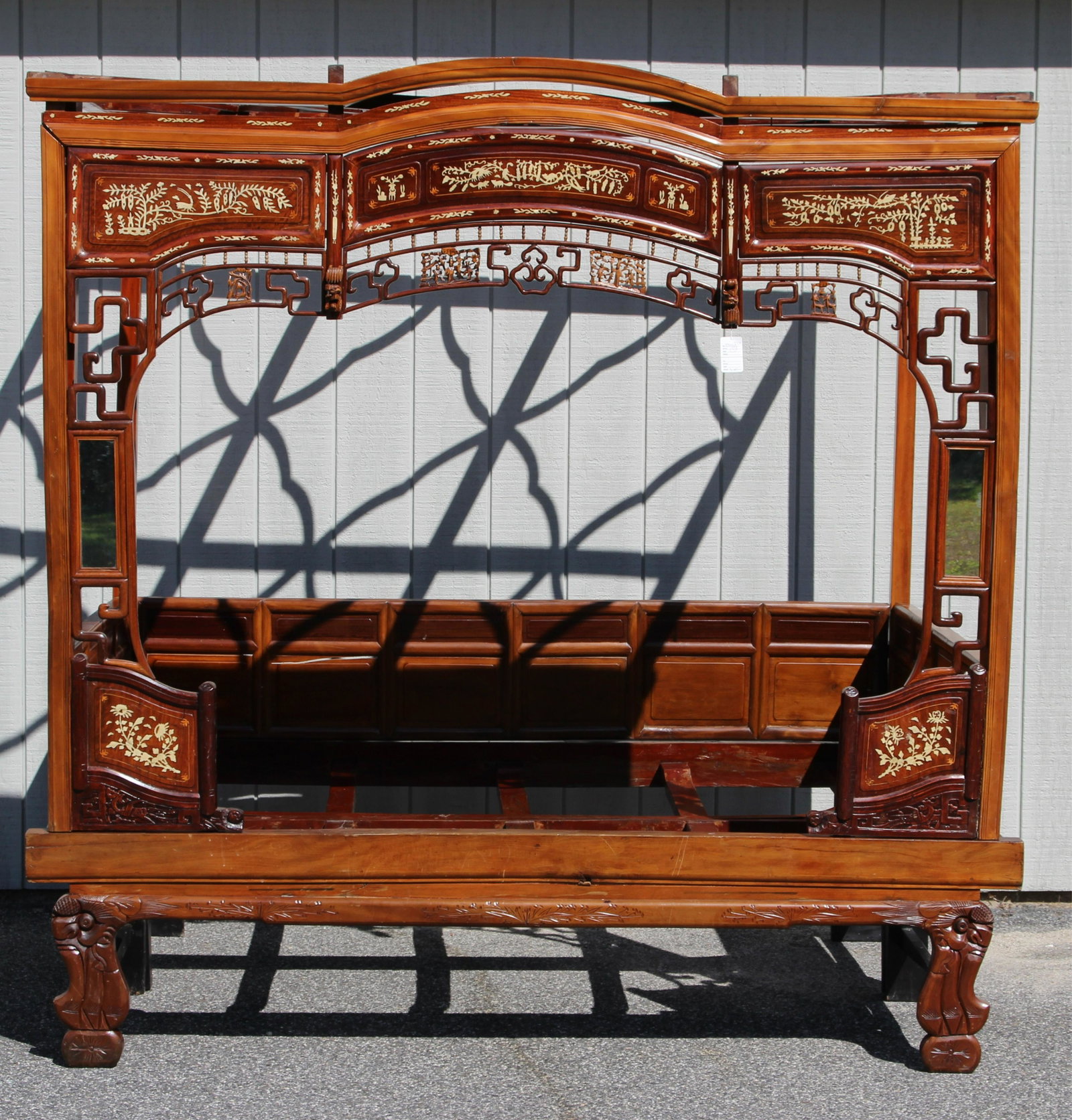 Chinese Opium/Marriage Bed, Inlaid, late 20th c.: with mirrored panels and a top frieze with three Communist-era framed color prints under glass, with a custom fitted cushion, can be disassembled for storage and shipping 82" H x 81" W x 54" D, the in