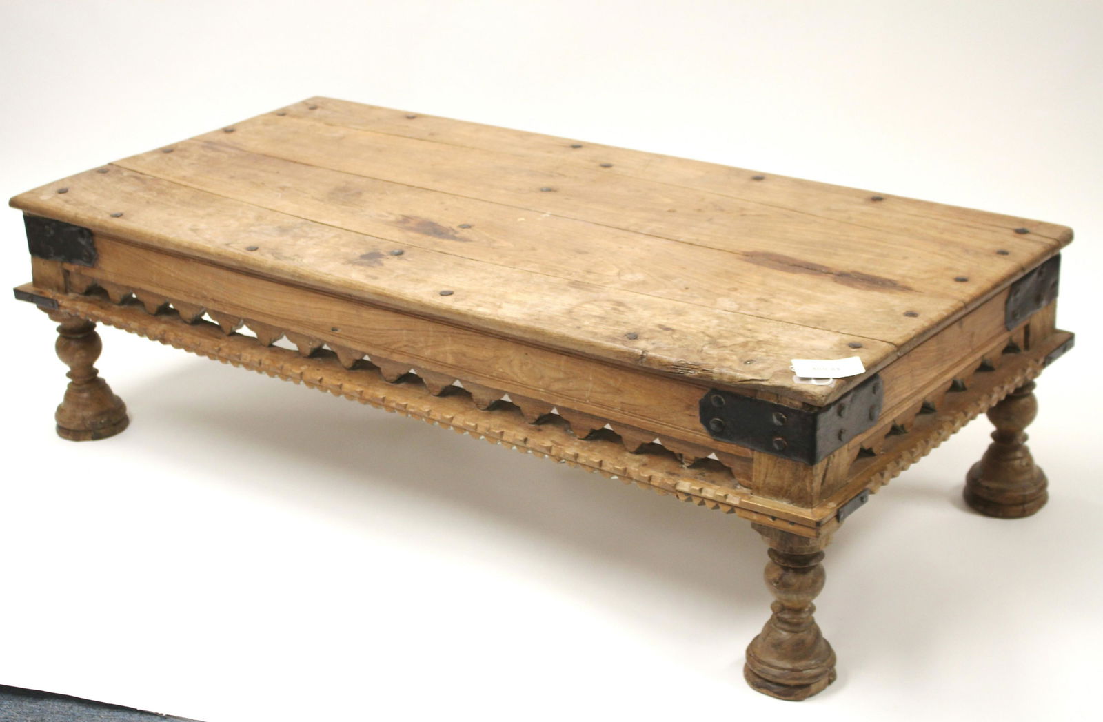 Indian Metal Mounted Teak Coffee Table: 15.5 H x 53.25 W x 25 D Litchfield Auctions is honored to offer Selections from the Collection of Peter Tillou. Peter has enjoyed wide renown across the United States and Internationally over his seve