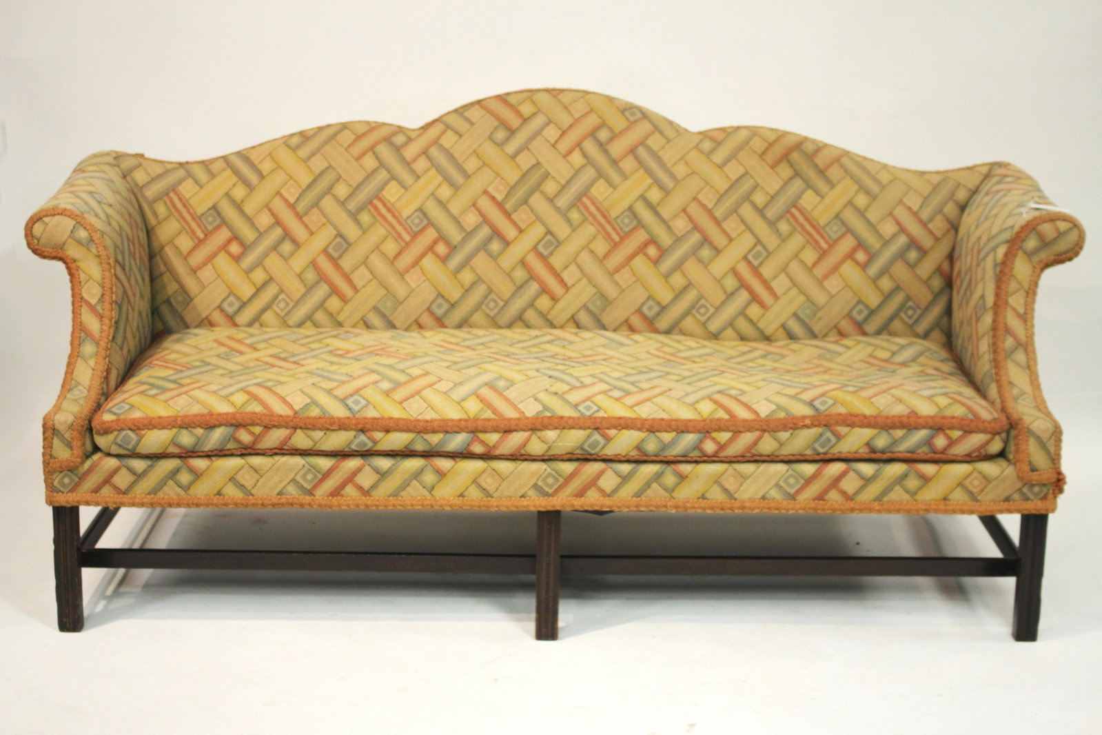 George III Style Mahogany Camelback sofa: Upholstered in rust colored simulated woven cotton 36.5 H x 82 W x 32 D Litchfield Auctions is honored to offer Selections from the Collection of Peter Tillou. Peter has enjoyed wide renown across the