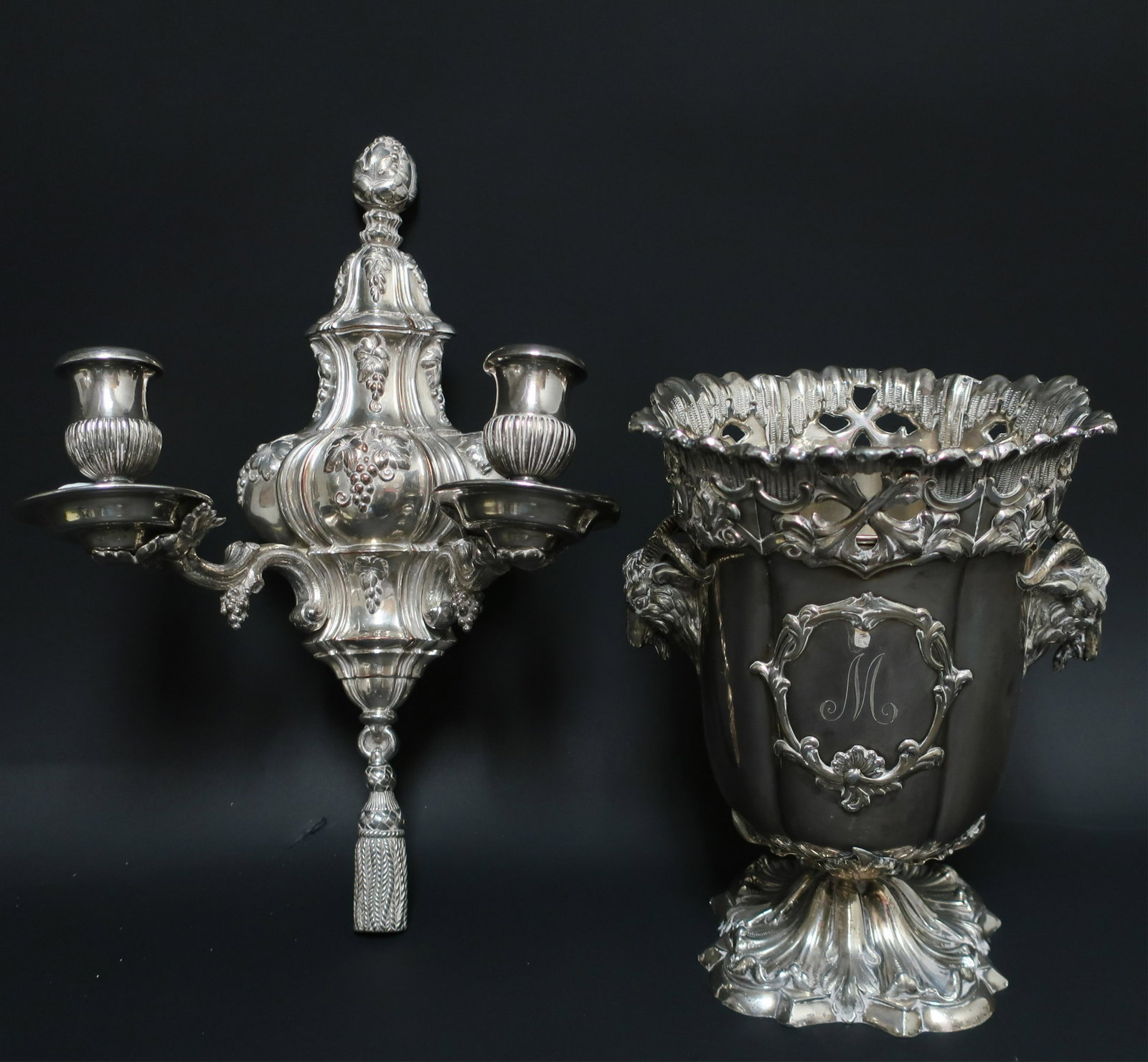 Good Silverplate: Wine Cooler and Sconce: the wine cooler probably 19th c, with an inner liner, rams heads, a dragon family crest on one cartouche and an "M" on the other, the two arm sconce with oak leaves and acorns terminating in a tassel,