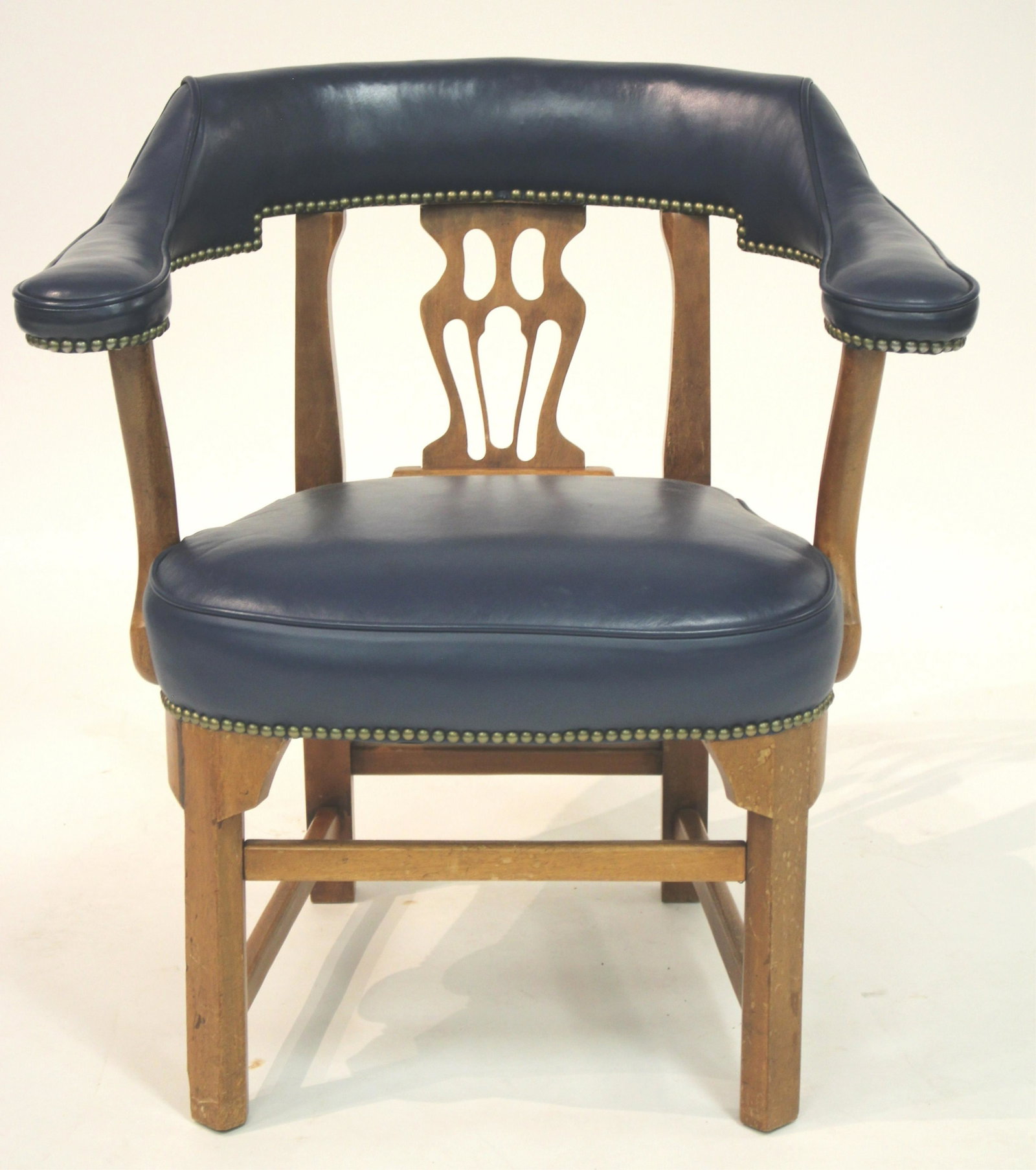 Windsor Captain's Chair: Paddle shaped arms; unique, exaggerated shaping of wood elements; brass nail heads. Blue leather upholstery. 31.5"H x 30W x 26D overall (KHAY10282)(JP)
