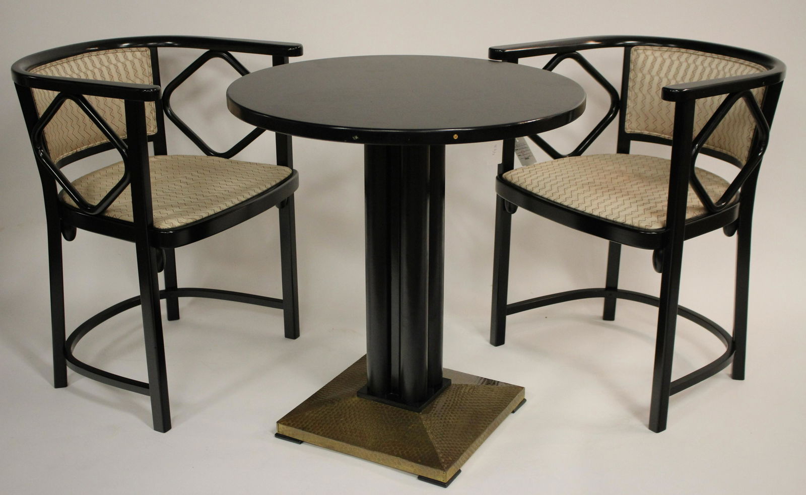 Secessionist Style Ebonized Table & 2 Arm Chairs: Contemporary reproductions in the style of Joseph Hoffman, the table w/ metal covered base, the chairs w/ silk upholstery. Table 29h x 27 diam, Chairs 28.5 x 22.5w x 18d x 18.5 seat height Property fr