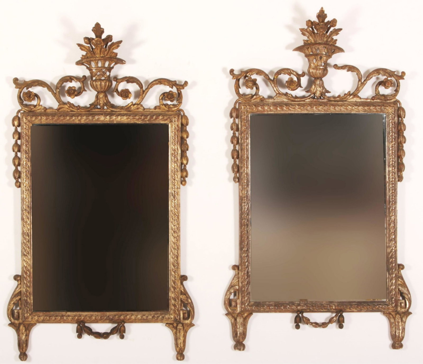 Near Pair English Rococo Mirrors: Similar decorative but carving/style differences to elements between the two. Antiqued silver finish. One with older mirror. Delicately formed baskets , floral scrolls, swags elements. 45"H x 24.5 (QL