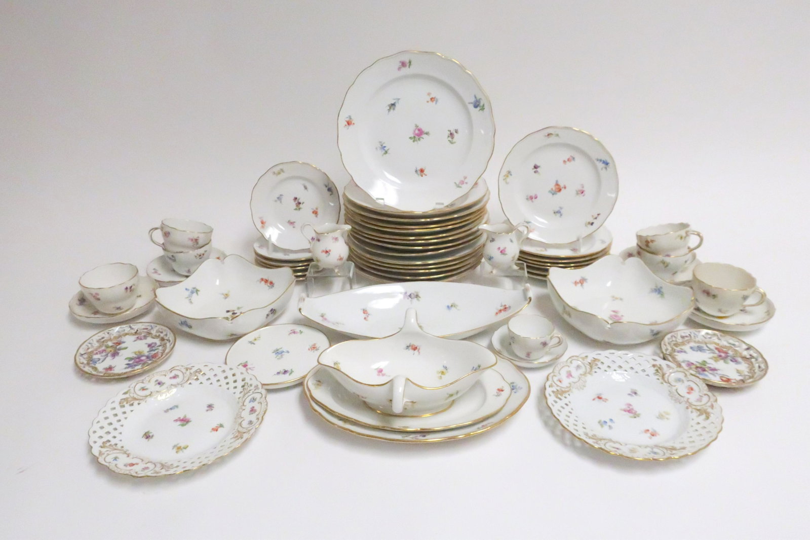 Meissen Porcelain Painted Dinner Service: In "Scattered Flowers" pattern comprised of 7 Dinner Plates (9.5 Diameter) 7 Soup Plates (9.75 Diameter) 7 Salad/Lunch Plates (7.5 Diameter) 6 Bread/Butter Plates (6 Diameter) 2 Reticulated Plates, Pa