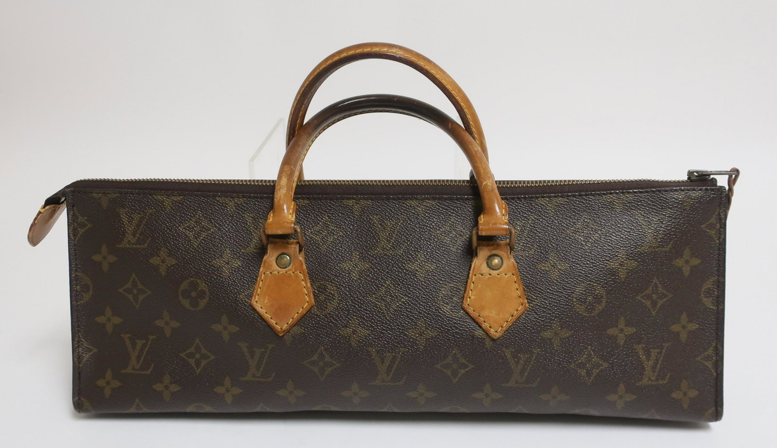 Louis Vuitton Vintage Sac Triangle: Monogram exterior, brown leather interior. 16 x 6 x 3 (GLO838)(EL)