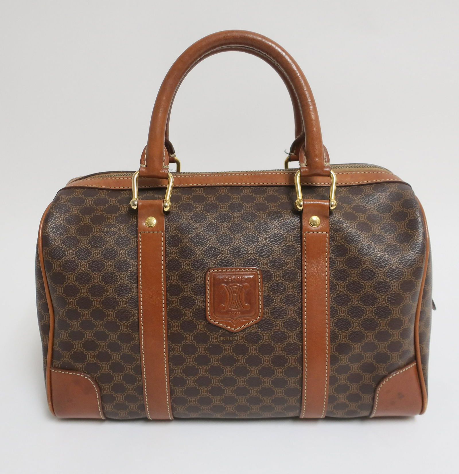 Celine Vintage Boston 30: Coated canvas Macadam exterior with unlined interior. Chestnut colored leather handles and details. Macadam interior zipped pocket. 11 x 8 x 6 (GLO845)(EL)