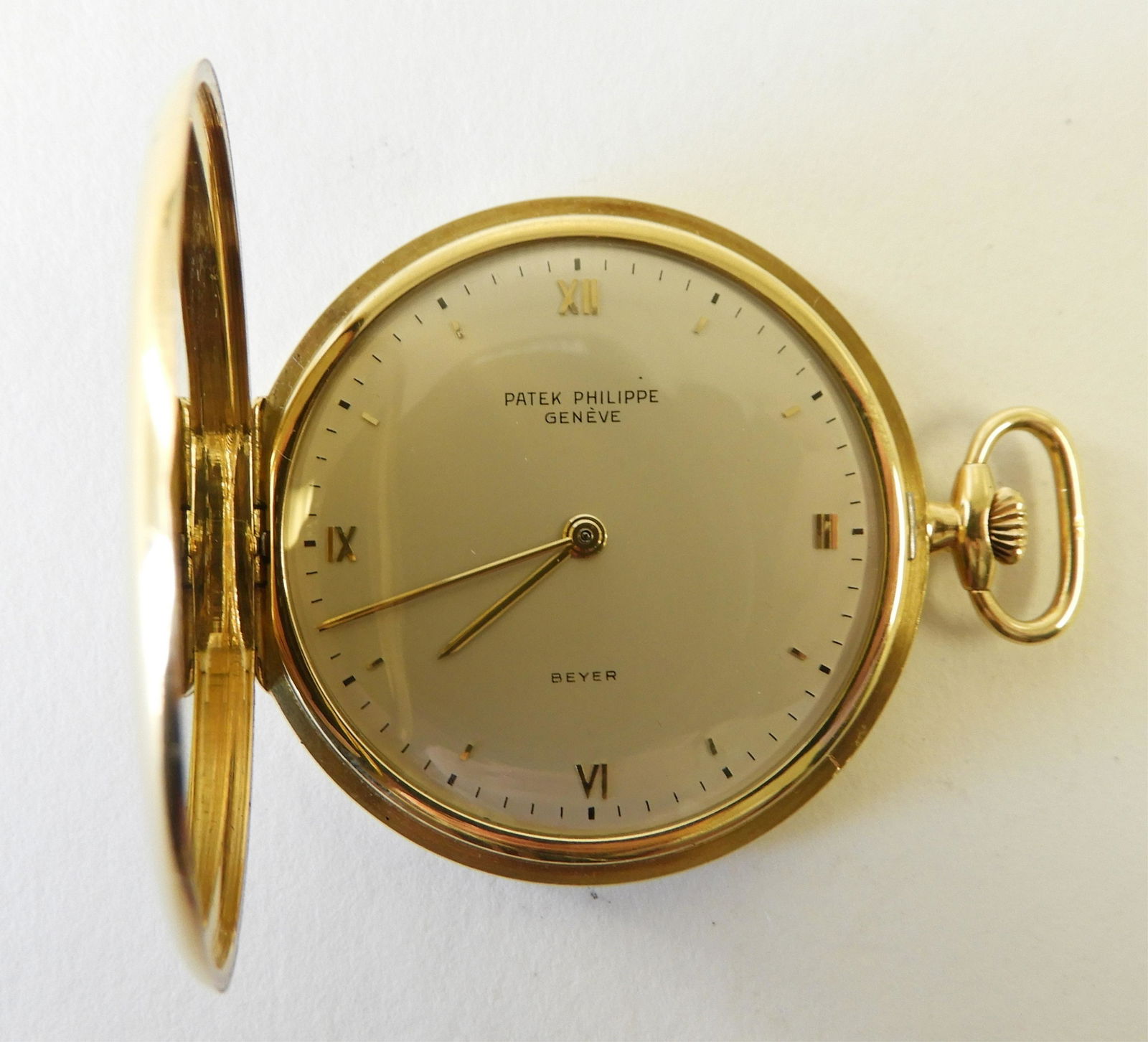 PATEK PHILIPPE - 18k Yellow Gold Pocket Watch: Polished 18k yellow gold hunter case, silvered dial stamped “Patek Philippe / Genève / Beyer”, raised yellow gold Roman numerals and chapters, case interior stamped “0,750 / 310011” and “0,